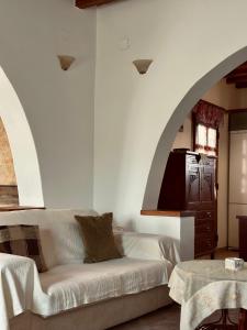 a living room with a white couch and an archway at Home Sweet Home Milos in Triovasálos
