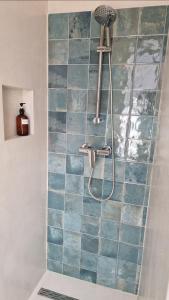 a bathroom with a shower with blue tiles at O Encanto no Centro de Coimbra in Coimbra +23 photos