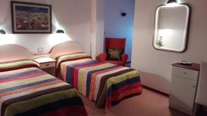 Postel nebo postele na pokoji v ubytování Hostal J.B