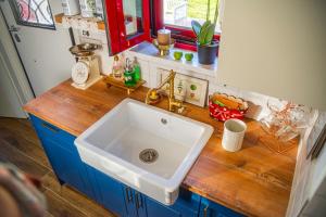 a kitchen with a sink and a wooden counter top at Vitta's House in Kanali +63 photos