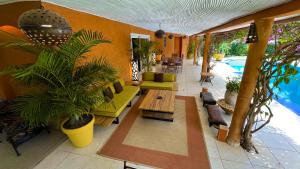 a living room with a pool and some plants at Villa Zehliana in Saly Portudal