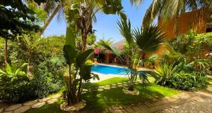 a resort with a swimming pool and palm trees at Villa Zehliana in Saly Portudal