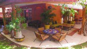 a patio with a table and chairs and plants at Villa Zehliana in Saly Portudal