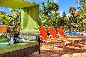 a group of chairs sitting next to a pool at Ocean Beach Club in Fort Lauderdale