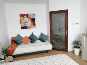 a room with a couch with colorful pillows on it at Medeea Studio in Alba Iulia