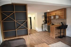 a living room with a large wall of shelves at Apartmani TEDŽ Plav in Plav