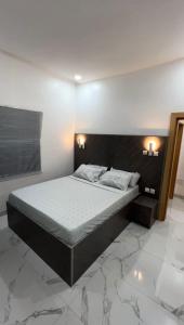 a bedroom with a large bed in a room at Keylah Guest House in Cotonou