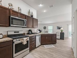 a kitchen with wooden cabinets and a stove top oven at 5682 Z6 VILLAGE OF DESOTO by REMAX Premier in The Villages