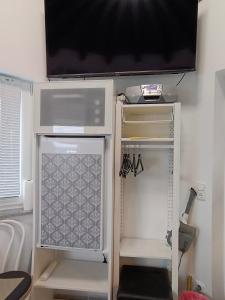 an open refrigerator with a tv on top of it at Single Tiny House Salzkammergut in Regau