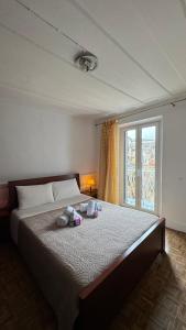 a bedroom with a bed with two pillows and a window at Vistas Venecianas Apartment Corfu Old Town in Corfu