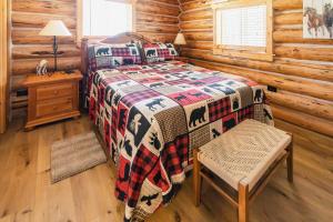 a bedroom with a bed in a log cabin at Firepit & Outdoor Dining|Sleeps 10|Dogs Welcome in Seeley Lake