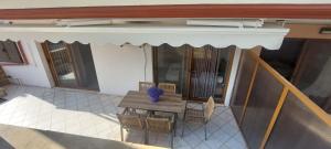 a table and chairs on a balcony with an awning at Petrino 2 semibased by Vasileia in Sarti