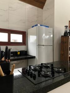 Kuchyň nebo kuchyňský kout v ubytování Chalé em Bananeiras - Condomínio Monte Sinai + 19 fotografií