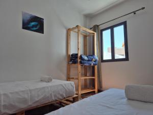 Postel nebo postele na pokoji v ubytování LAFAMILIA SURF imsouane