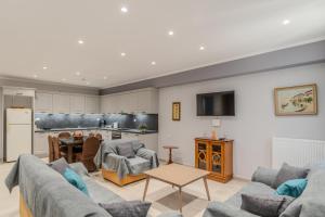 a living room with two couches and a kitchen at Dionysis Elegant Cozy Apartment in Filiatra
