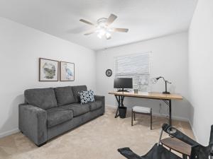 a living room with a couch and a desk at 928 Z5 VILLAGE OF LAKE DENHAM by REMAX Premier in Leesburg