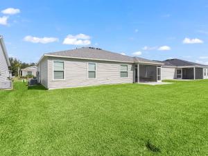 a house with a large yard with green grass at 928 Z5 VILLAGE OF LAKE DENHAM by REMAX Premier in Leesburg