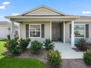 a house with a porch and a lawn at 928 Z5 VILLAGE OF LAKE DENHAM by REMAX Premier in Leesburg
