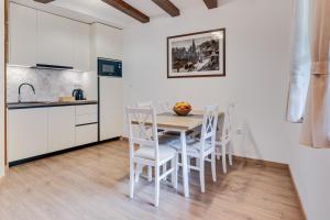 a kitchen and dining room with a table and chairs at Rastoke 10 in Slunj