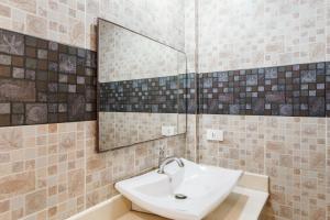 a bathroom with a sink and a mirror at Samui Pier Beach Front & Resort in Bang Rak Beach +33 photos