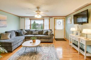 a living room with a couch and a tv at Day Trip to Acadia Quiet Coastal Maine Escape in Harrington