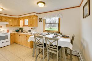 a kitchen with a table and chairs and a kitchen with a sink at Day Trip to Acadia Quiet Coastal Maine Escape in Harrington
