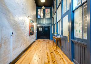 a hallway with a wooden floor in a building at Quaint Retreat for 2 Heart of DT Near Broadway in Nashville