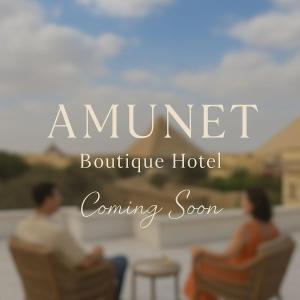 a picture of two people sitting in chairs on a porch at AMUNET Pyramids View Boutique Hotel in Cairo