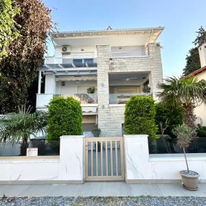 a house with a gate in front of it at Marko's Place in Hanioti