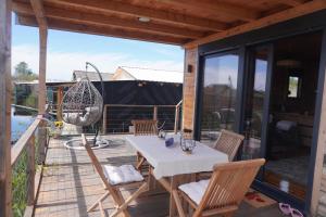 a patio with a table and chairs on a deck at Era Cottage in Ulcinj