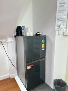 a small refrigerator in a corner of a room at Hotel4U Koh Tao in Ko Tao