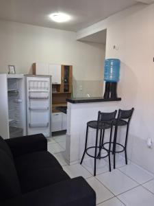 a kitchen with two chairs and a counter in a kitchen at Apartamento Premium Grand Luxo in Fortaleza