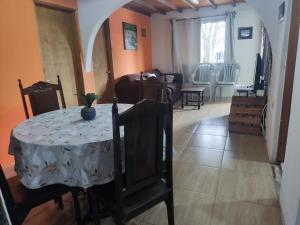 a room with a table and a living room at Alojamiento Carol in Melo