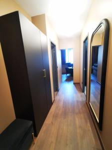 a hallway with two doors and a hallway with a table at Appart'Hôtel Le Phoenix in Montbéliard