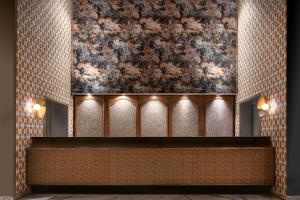 a lobby with a painting of flowers on the wall at AC Hotel Ciudad de Sevilla by Marriott in Seville +39 photos