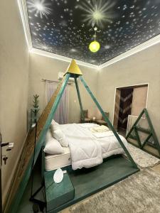 a bedroom with a bed with a star ceiling at مفتاح الحياه in Banī Ghālib