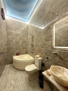 a bathroom with a toilet and a sink at مفتاح الحياه in Banī Ghālib +26 photos