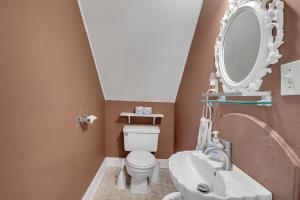 a bathroom with a sink and a toilet and a mirror at Doyle House - Near Cooperstown Dreams Park 2 in Milford