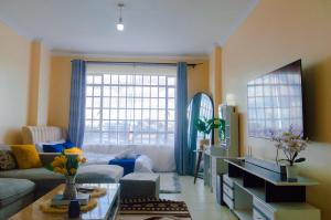 a living room with a couch and a table at mama ori apartments in Nairobi