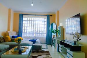 a living room with a couch and a table at mama ori apartments in Nairobi