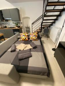 a room with a bed with pillows and a staircase at Casa Angelina in Molfetta