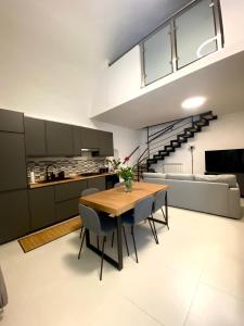 a kitchen and dining room with a table and chairs at Casa Angelina in Molfetta