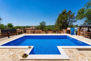 a pool in a backyard with a wooden fence at MY DALMATIA - Holiday home Burgija with private swimming pool in Benkovac +82 photos