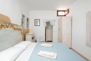 a bedroom with a bed with two towels on it at Terrazza fronte Mare in Castro di Lecce