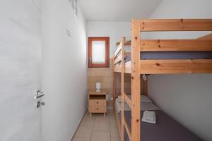 a small room with a bunk bed and a bathroom at Terrazza fronte Mare in Castro di Lecce