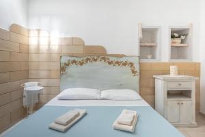 a bedroom with a bed with two towels on it at Terrazza fronte Mare in Castro di Lecce