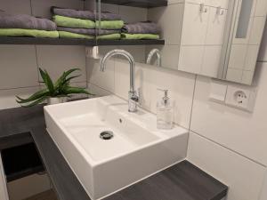 a white sink in a bathroom with towels at Buten un Binnen in Norderney +56 photos