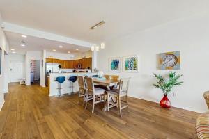 a kitchen and dining room with a table and chairs at Harborview Grande 402 in Clearwater Beach +20 photos