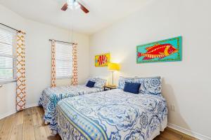 a bedroom with two beds and a ceiling fan at Harborview Grande 402 in Clearwater Beach