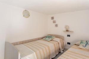 A bed or beds in a room at Vista Sul Pan di Zucchero - Terrazza vista mare a Nebida